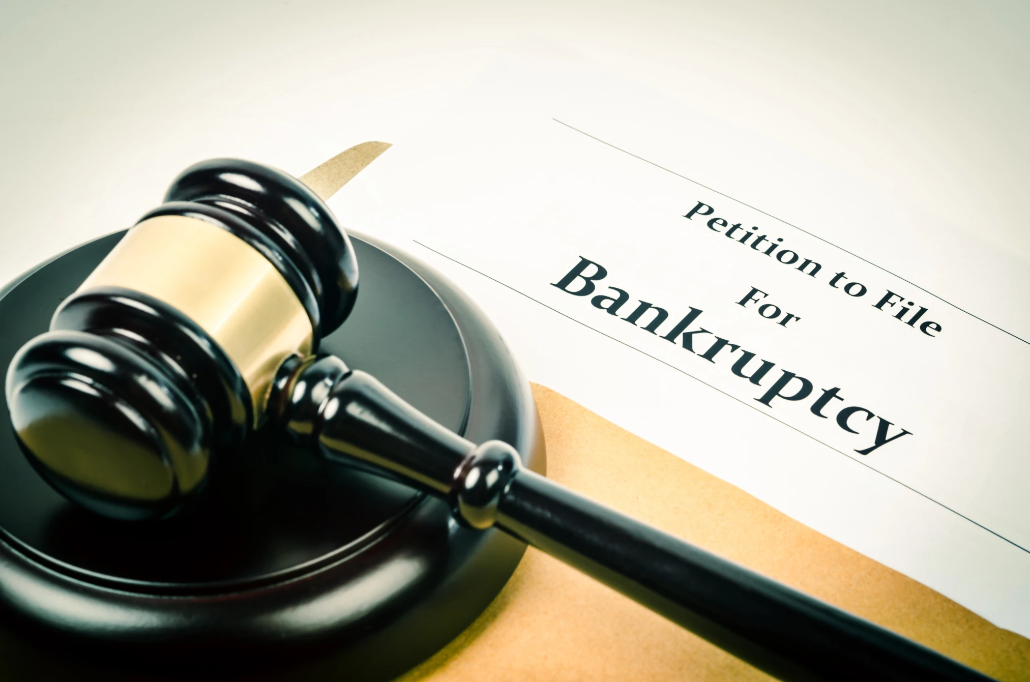 Professional bankruptcy law consultation - attorney reviewing financial documents with client seeking debt relief
